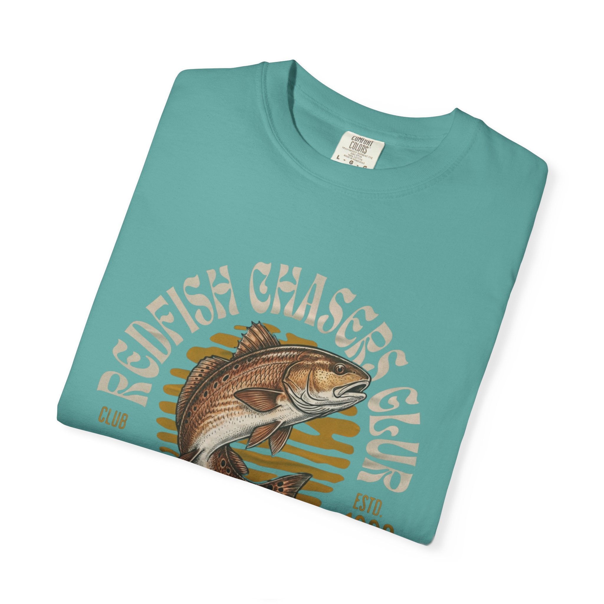 Folded teal t-shirt with redfish graphic and 'Redfish Chasers Club' text on a white background