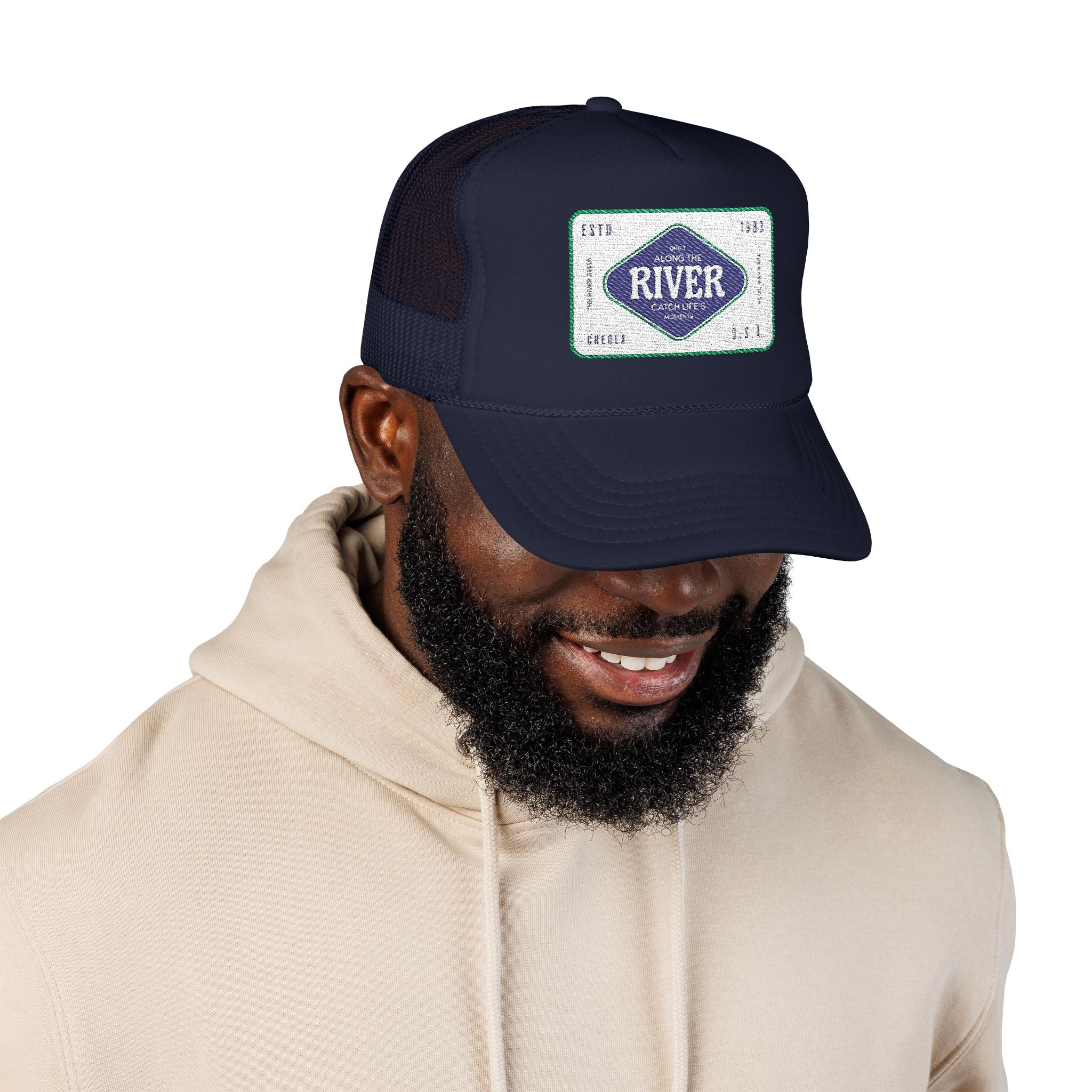 Man wearing a navy blue cap with a logo of the River Delta based in Creola Alabama 