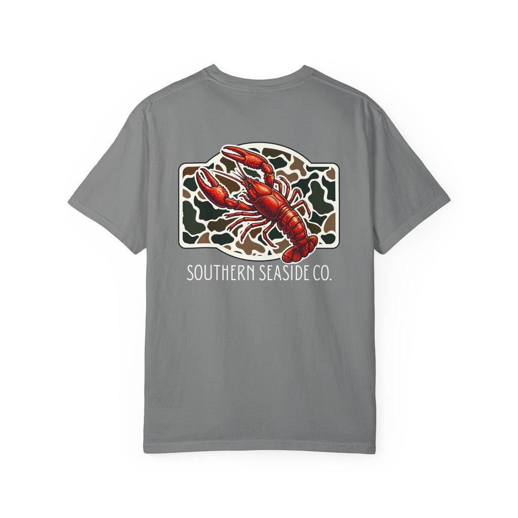 Crawfish T-Shirt. Gray comfort colors t-shirt with a crawfish graphic design and 'Southern Seaside Co.' logo with a camo print background.