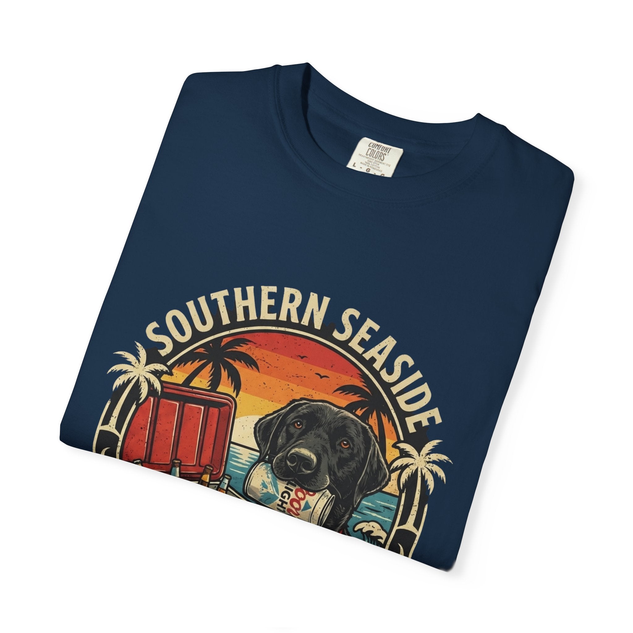 Folded navy blue t-shirt with 'Southern Seaside' graphic design featuring a dog holding a beer in his mouth and a cooler of beer on the beach. 