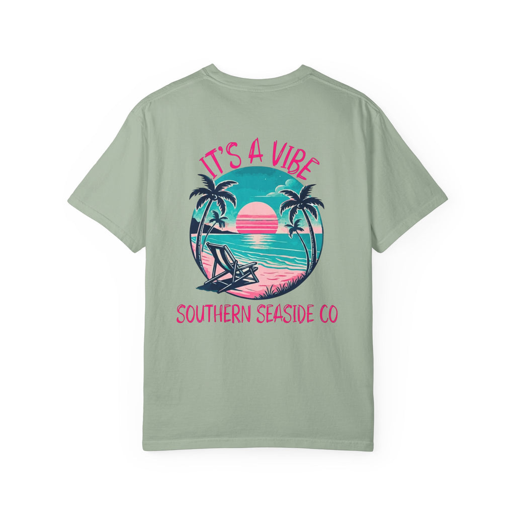 Light green t-shirt with a beach graphic and 'It's a Vibe' text on a white background