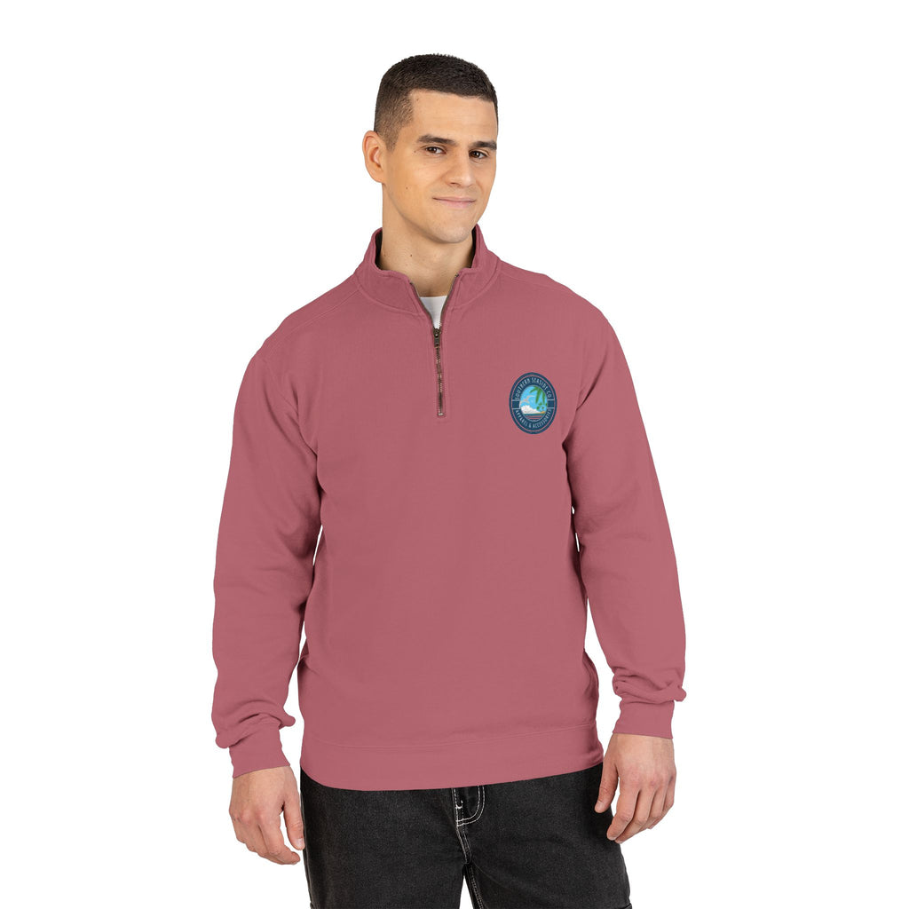 Man wearing a maroon pullover with a logo on a white background