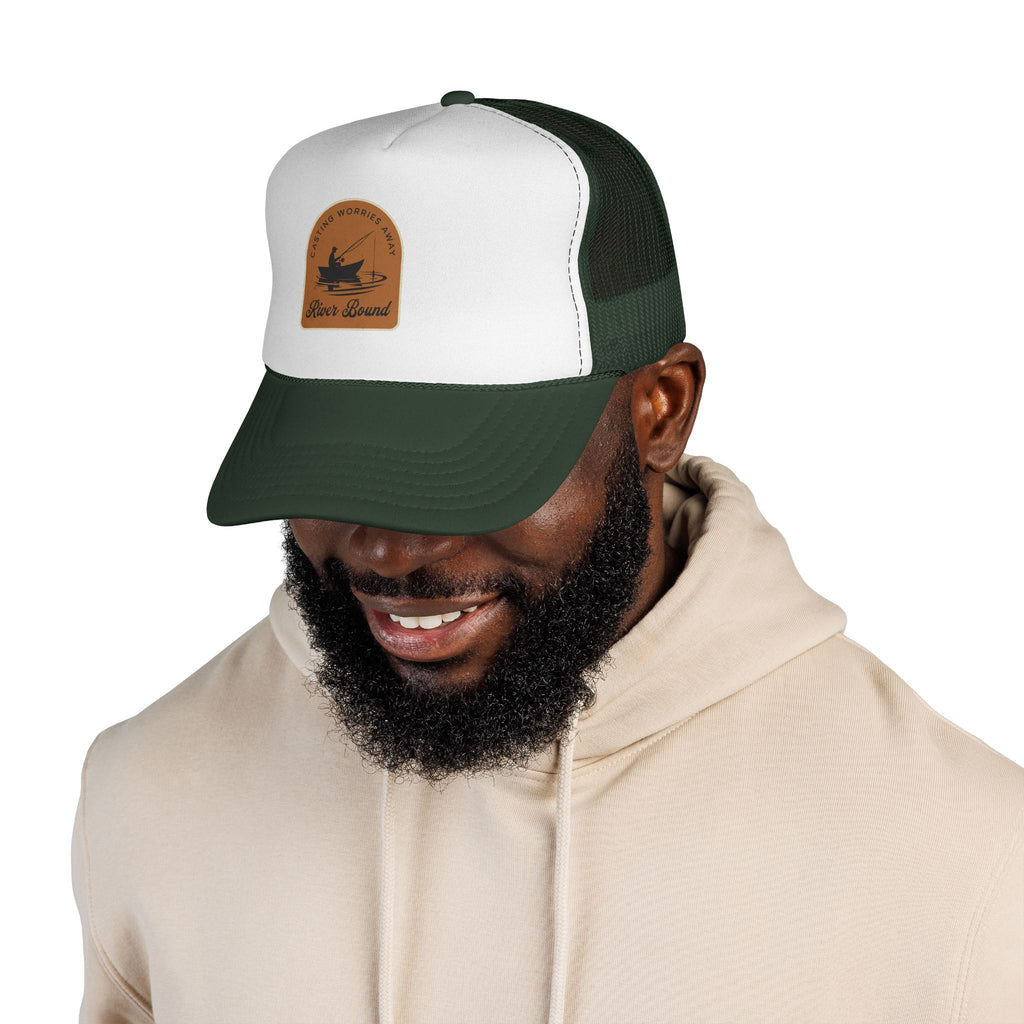 Man wearing a white and green fishing cap with a logo on a white background
