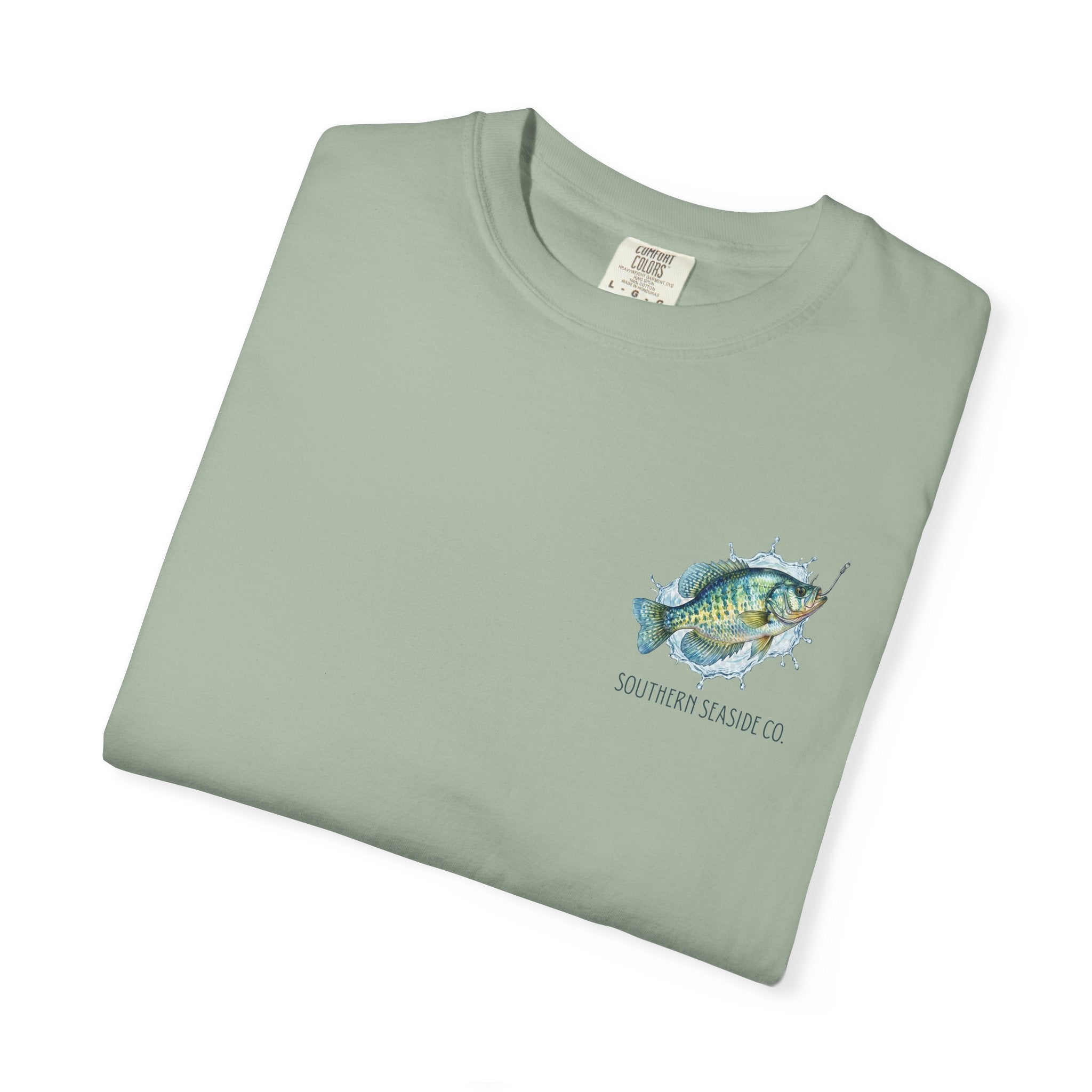Folded light green t-shirt with a crappie fish graphic and 'Southern Seaside Co.' text on a white background