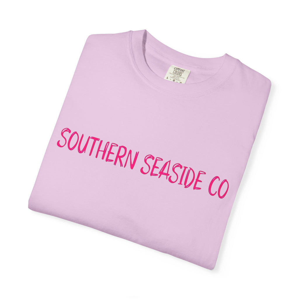 Folded pink t-shirt with 'Southern Seaside Co' text on a white background