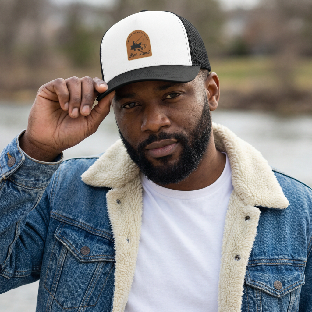 Man wearing a river fishing cap with a logo