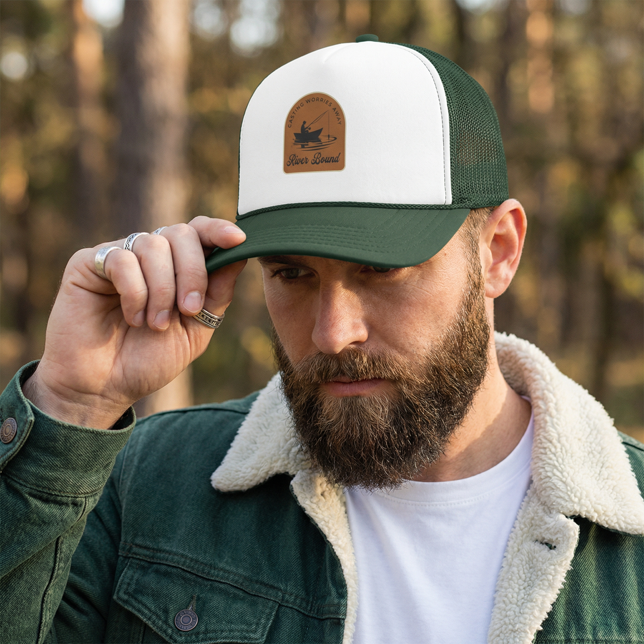 Man wearing a green and white river fishing cap with a logo "River Bound" 
