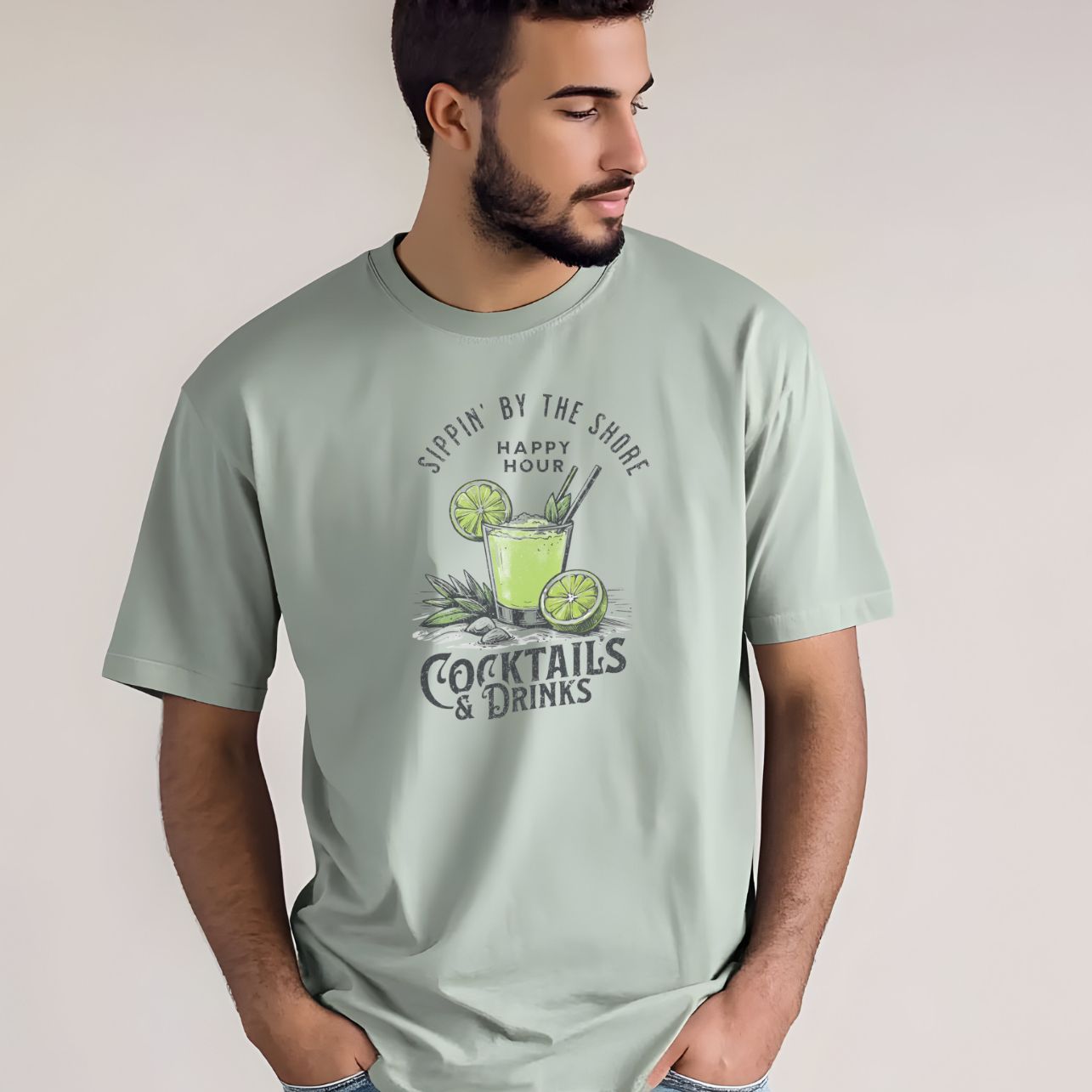Man wearing a light green t-shirt with a cocktail graphic and text.