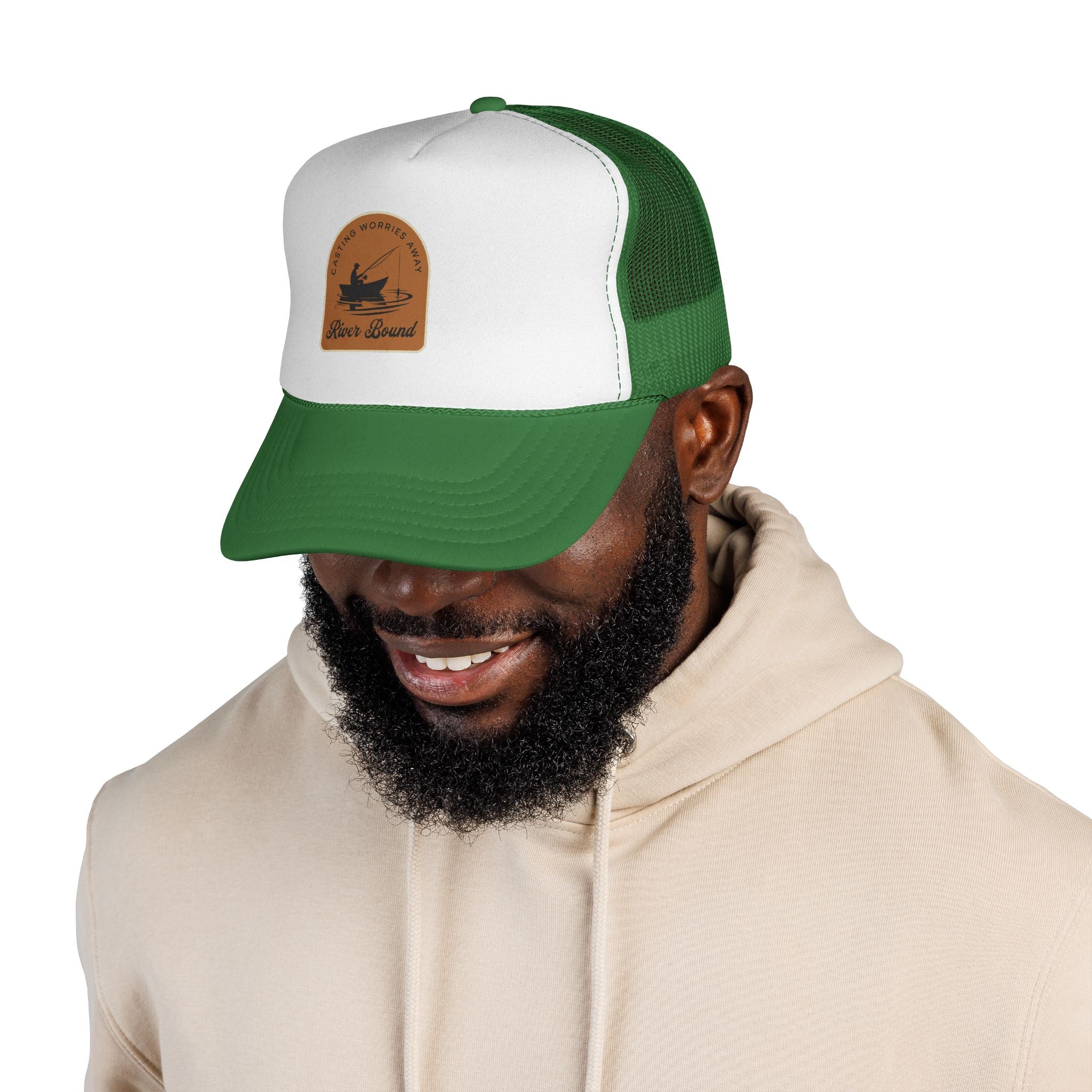 A river fishing hat. Man wearing a green and white cap with a logo on a white background