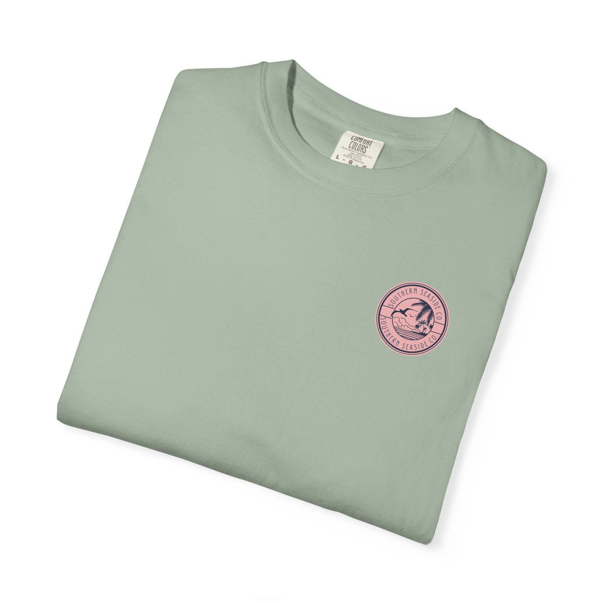 Folded light green t-shirt with a pink logo on a white background