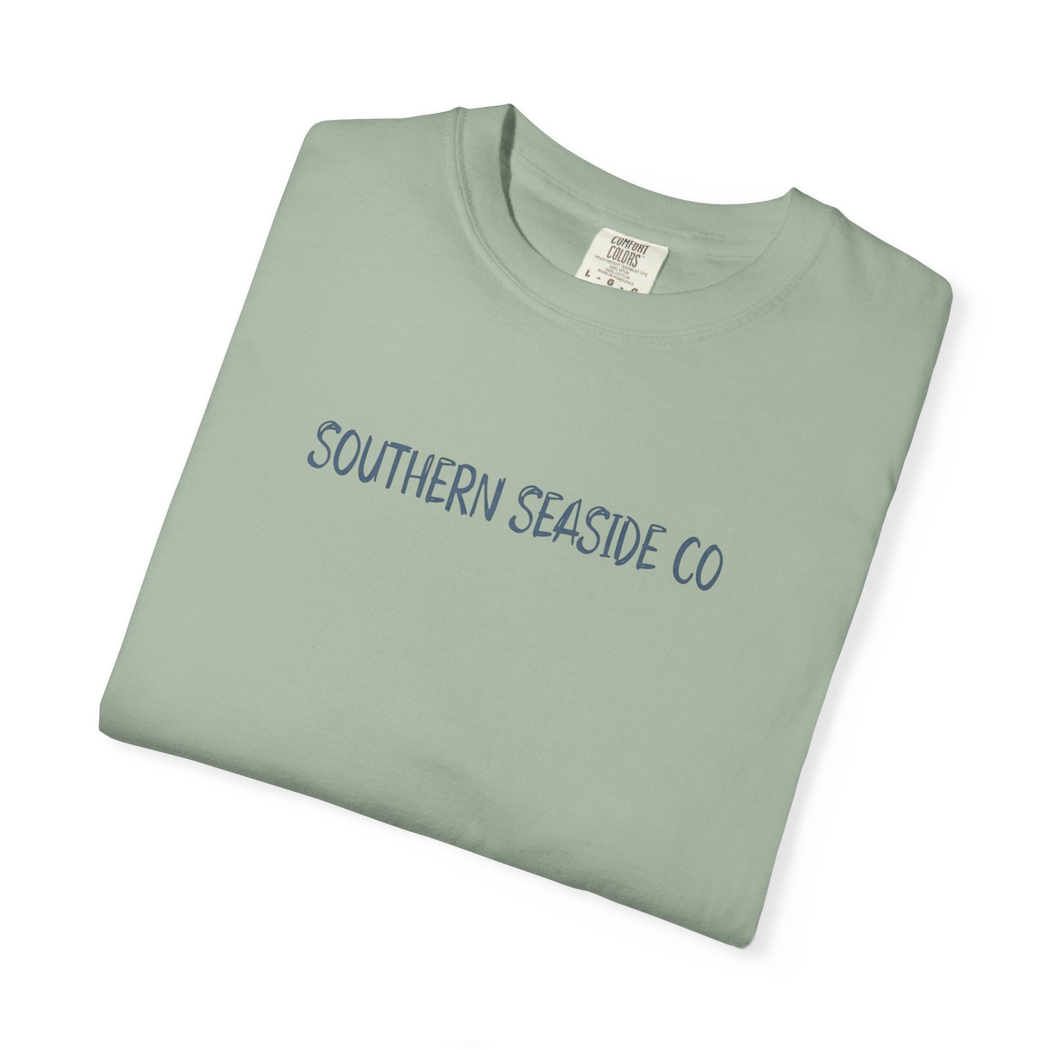 Folded light green t-shirt with 'Southern Seaside Co' text on a white background