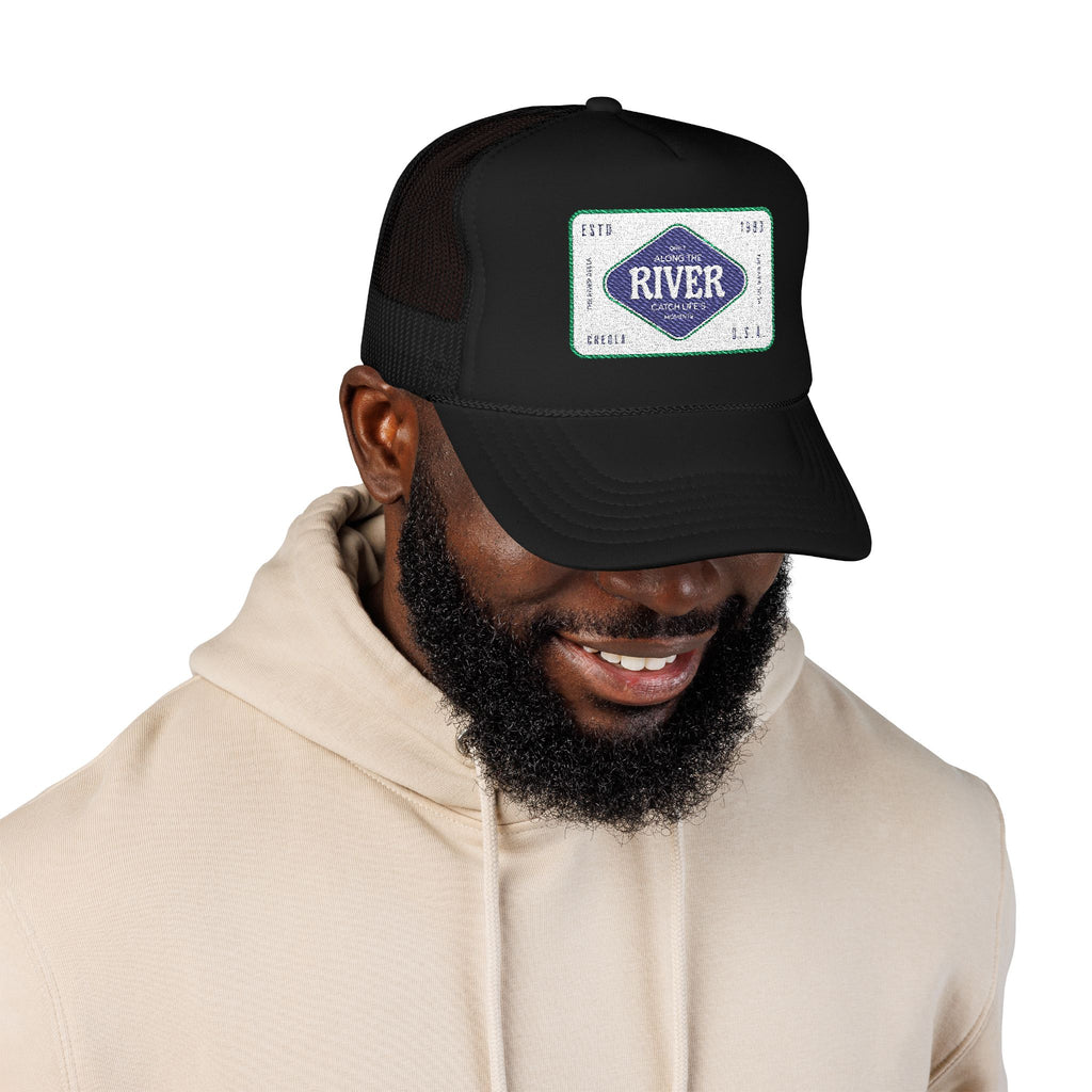 Man wearing a black cap with a logo of the river delta details based in Creola Alabama white background