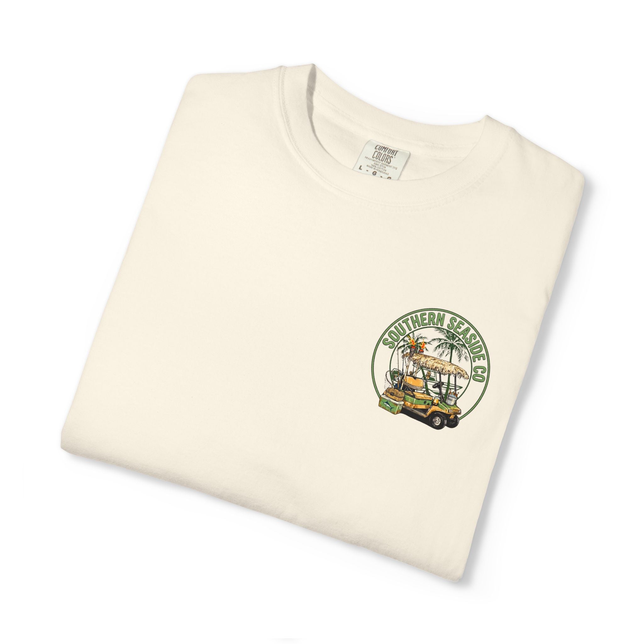 Folded cream-colored t-shirt with a golf cart and fishing graphic design with Southern Seaside Company logo