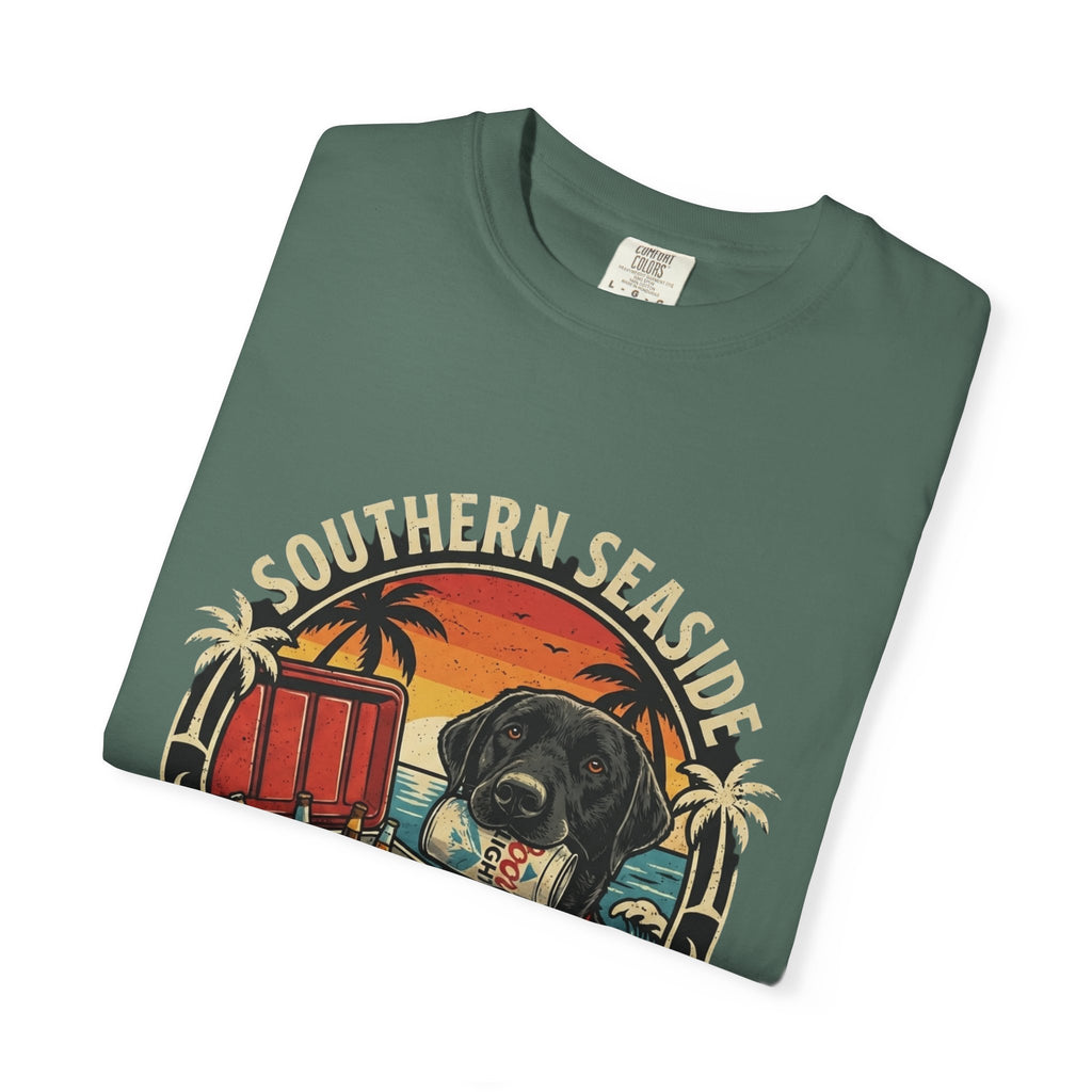 Folded green t-shirt with 'Southern Seaside' graphic design featuring a dog and a cooler of beer on the beach.