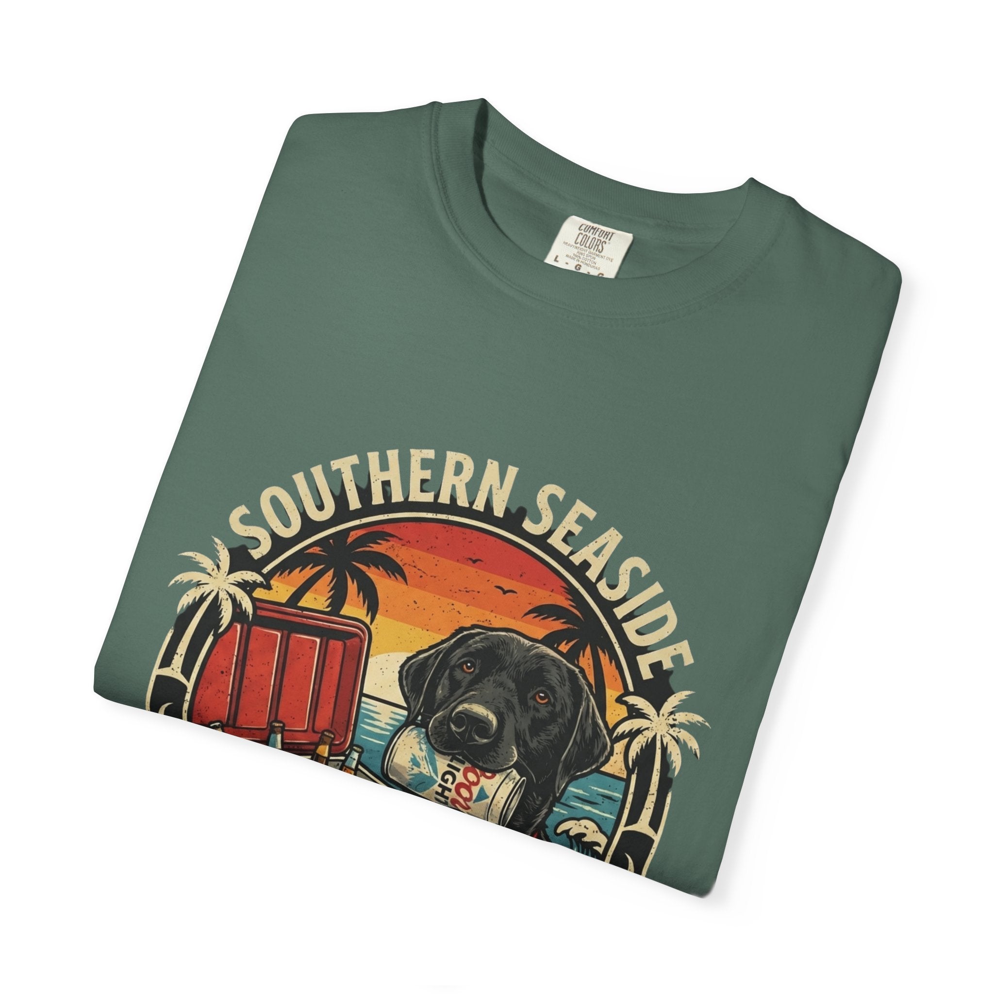 Folded green t-shirt with 'Southern Seaside' graphic design featuring a dog and a cooler of beer on the beach.