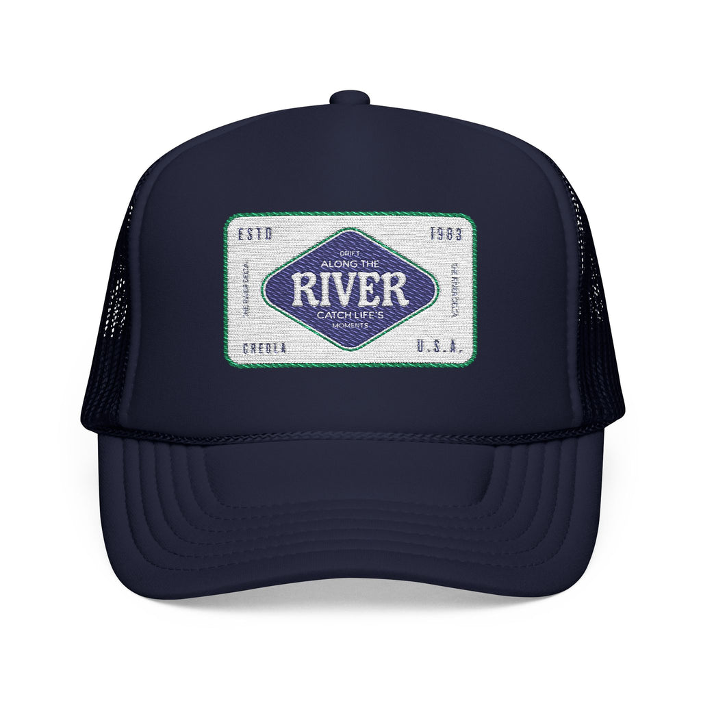 Navy blue trucker hat with the logo of Along The River Catching Life's Moments based in Creola Alabama river delta.