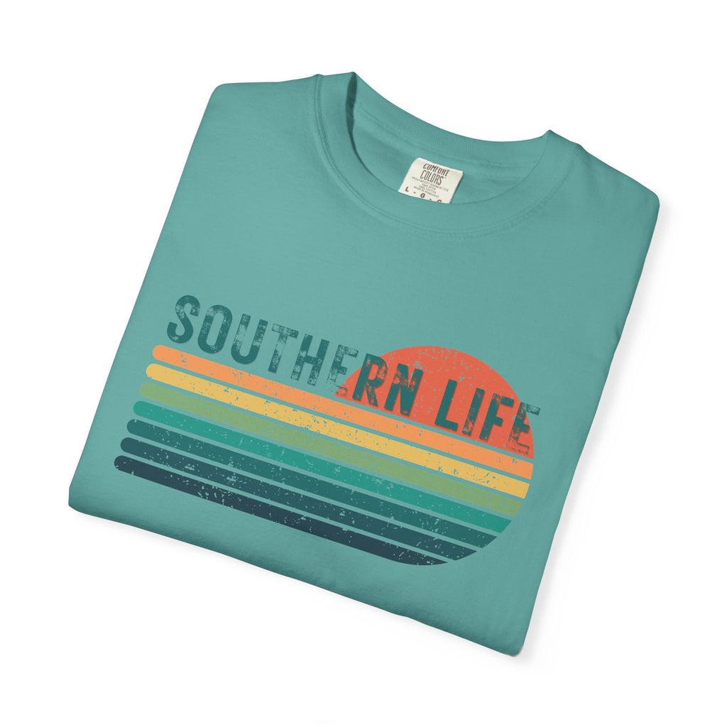 Folded teal t-shirt with 'Southern Life' graphic on a white background